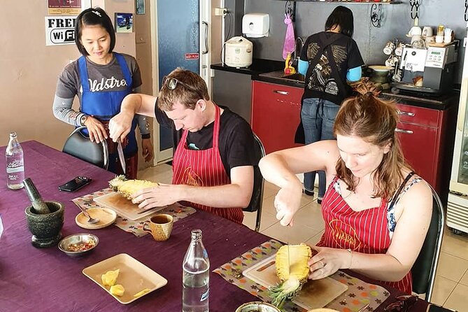 Thai Cooking Class with Market Tour in Phuket by VJ - Making curry paste with a mortar and pestle